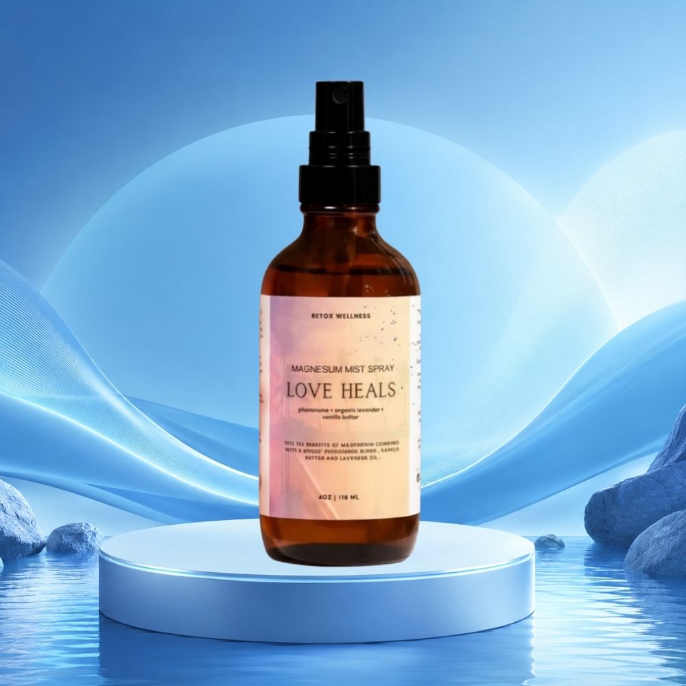 An amber glass spray bottle labeled 'Love Heals' by RYU Wellness, 